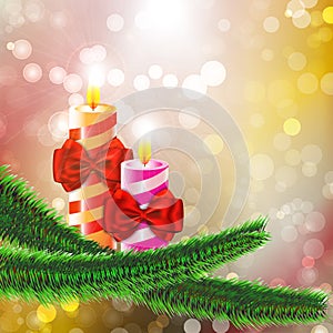 Two burning candles with bows on Christmas tree branch