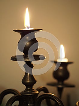 Two burning candles of life in a candlestick.