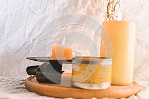 Two burning candles on wooden tabel and white background