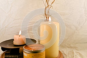 Two burning candles on wooden tabel and white background