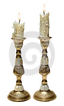 Two burning old candles in Golden candlesticks