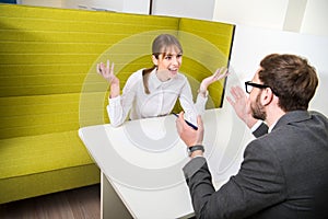 Two business colleagues having debate and sitting