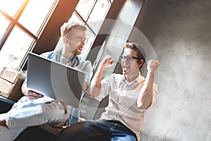 Two business colleagues sitting at a table, having a meeting.