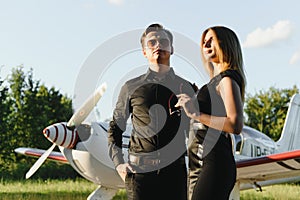Two business colleagues standing by a plane