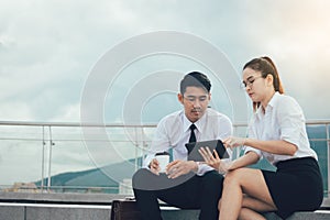 Two business couple using digital tablet working together.