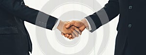 Two business executive shake hand in boardroom for merger and acquisition. Shrewd