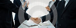 Two business executive shake hand in boardroom for merger and acquisition. Shrewd