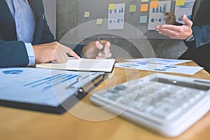Two business executives analyzing data paper at meeting room