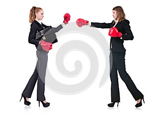 Two business ladies boxing isolated on white