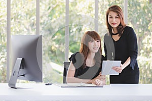 TWO BUSINESS LADIES IN OFFICE