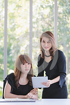 TWO BUSINESS LADIES IN OFFICE