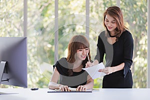 TWO BUSINESS LADIES IN OFFICE