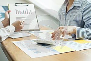 Two business leaders talk about charts, financial graphs showing results are analyzing and calculating planning strategies,