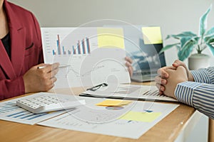 Two business leaders talk about charts, financial graphs showing results are analyzing and calculating planning strategies,