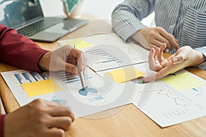 Two business leaders talk about charts, financial graphs showing results are analyzing and calculating planning strategies,