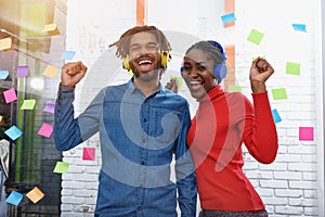 Two business listen to music in office