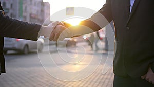 Two Business man handshake with blurred city background