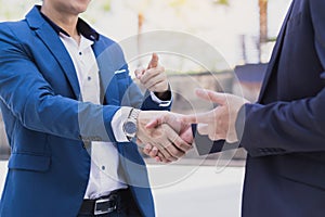 Two business man making handshake in the city. Business etiquette, congratulation, merger and acquisition concepts