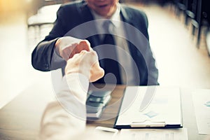 two business man use hand to fist bump