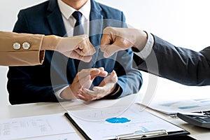 Two business man use hand to fist bump