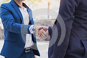 Two business man making handshake in the city. Business etiquette, congratulation, merger and acquisition concepts photo