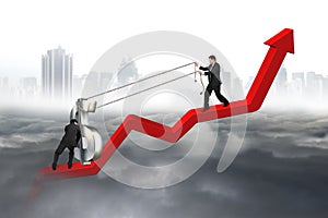 Two business men moving dollar sign upward red trend line