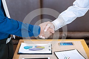 Two business men shake hand and discuss together for agreement s