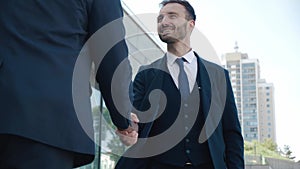 Two business men shake hands when meeting, agree to a deal or say hello. Portrait of handshake of two smiling