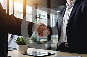 two business men shake hands in the office