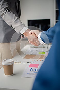 Two business men shake hands, Two businessmen are agreeing on business together and shaking hands after a successful negotiation.