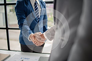 Two business men shake hands, Two businessmen are agreeing on business together and shaking hands after a successful negotiation.