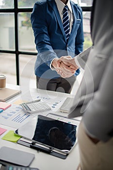 Two business men shake hands, Two businessmen are agreeing on business together and shaking hands after a successful negotiation.