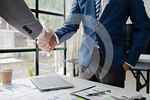 Two business men shake hands, Two businessmen are agreeing on business together and shaking hands after a successful negotiation.