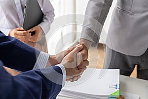 Two business men shake hands, Two businessmen are agreeing on business together and shaking hands after a successful negotiation.