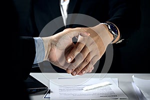 Two business men shaking hands after a job interview or agreement for cooperation.