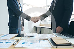 Two business men shaking hands during a meeting to sign agreement and become a business partner, companies, confident, success de