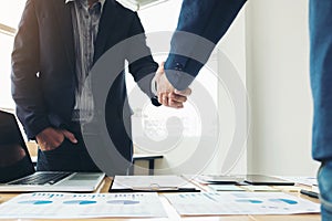 Two business men shaking hands during a meeting to sign agreement and become a business partner, enterprises, companies, confident