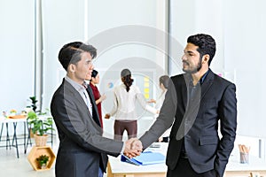 Two business partners shake hands after concluding a business finished in the office. Business to succeed concept, Collaborative