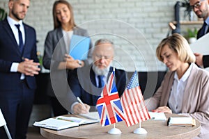 Two business partners signing a document. The United States of America and Great Britian photo