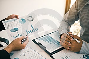 Two business partnership coworkers analysis strategy and gesturing with discussing a financial planning graph and company budget