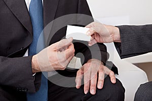 Two business people exchanging visiting card photo