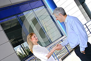 Two Business People Greet-2 photo