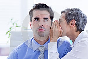 Two business people looking at a paper while working on folder