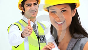 Two business people with safety helmet