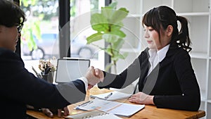 Two business people shaking hands after negotiations.