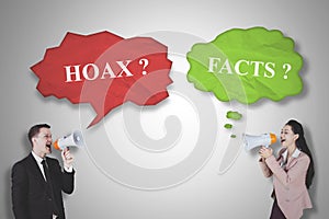 Two business people shouting fact and hoax