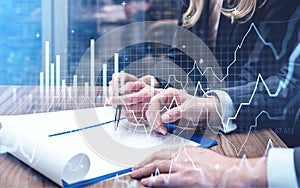 Two business people traders working together to develop new trading strategy. Stock market changes, business line graphs. Concept