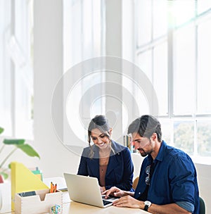 Two business people using laptop computer colleagues working in office sharing ideas