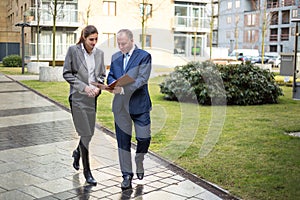 Two business people walking and discussing