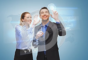 Two business people working with virtual screen